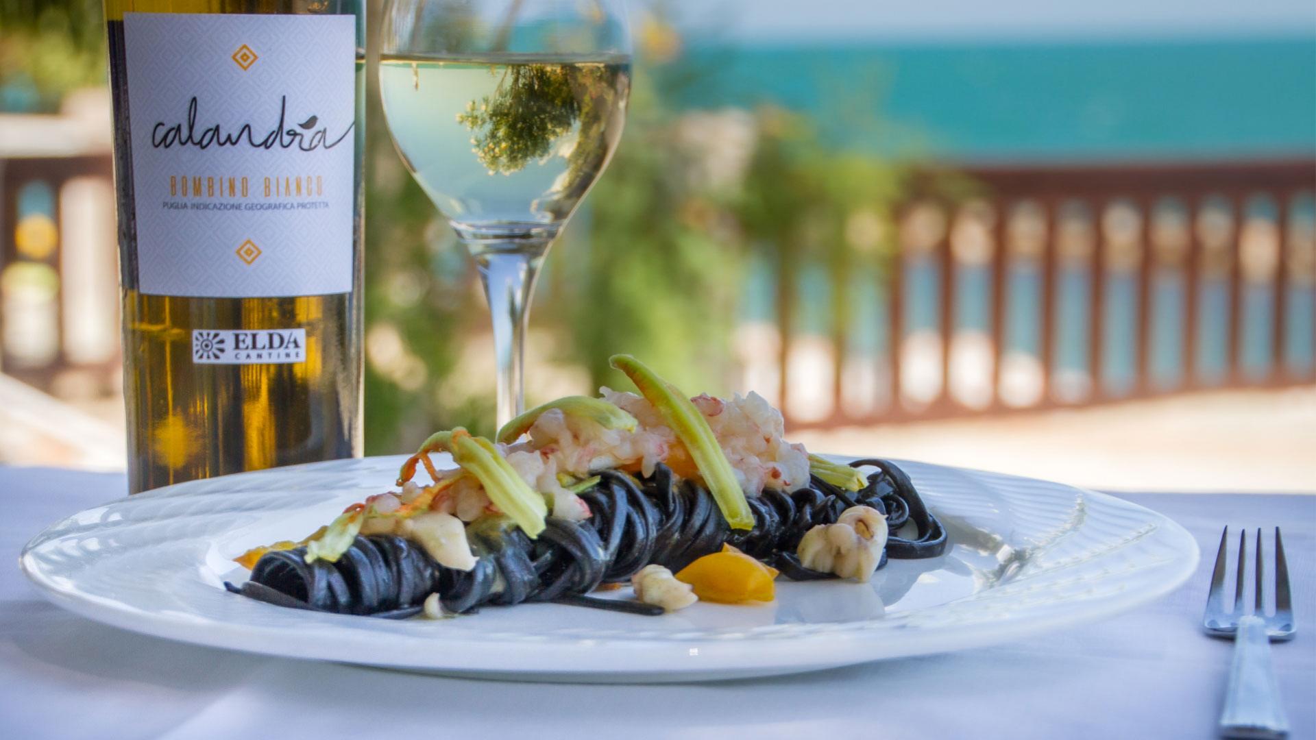 Piatto di pasta al nero di seppia con vino bianco Calandra Bombino Bianco.